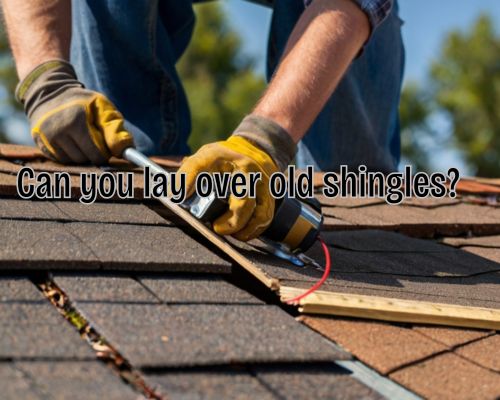 a worker laying over old shingles