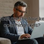 a coach reading through his laptop