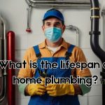 a plumber standing in front of his plumbing work with his complete PPE